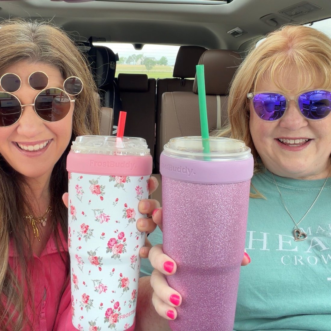 Sherry and Kimberly in the car holding up their matching tumblers